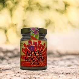 Organic nutmeg powder in a glass jar with a vibrant red and orange label featuring the text "Noce moscata" (Italian for "nutmeg").
