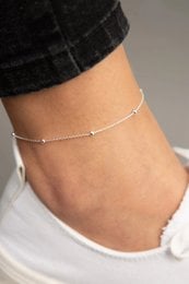 Delicate gold, rose gold, or silver anklet with a simple, elegant design. Suitable for everyday wear.
