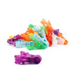  Assorted color pig-shaped pencil clipper. Vibrant, playful design with various bright colors including yellow, orange, green, and purple. Compact, portable size suitable for office or school use.