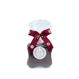  Honey gingerbread chocolate package in a burgundy gift box with a white bow and snowflake design. The package contains a variety of praline chocolates.