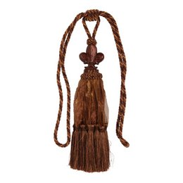  Decorative curtain tassel in a rich brown color, featuring a fleur-de-lis design and a long, braided cord. Suitable for use on curtains, draperies, or other home decor items.