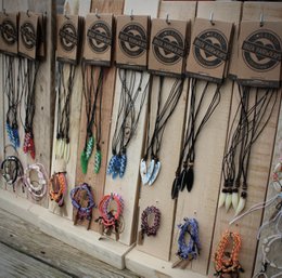  Display chains, wooden display with hanging necklaces and jewelry

The image shows a wooden display with several hanging necklaces and jewelry pieces. The display has a rustic, natural appearance with carved circular designs. The necklaces and jewelry appear to be made of various materials such as beads, stones, and metal. This display would be suitable for showcasing and selling jewelry or accessories in a retail or craft setting.