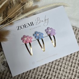  Pink and gold hair clips with floral designs. Suitable for kids.