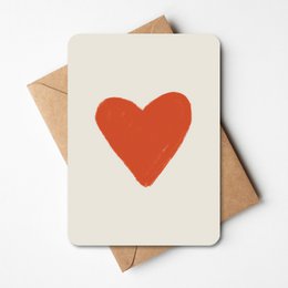 A greeting card with a simple, bold red heart design on a cream-colored background. The card is accompanied by a brown envelope, suggesting it is a love-themed card.