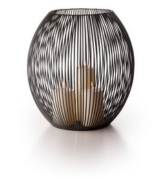 A large, round lantern with a black metal frame and a warm, glowing interior. The lantern has a distinctive striped pattern that creates an interesting visual effect.