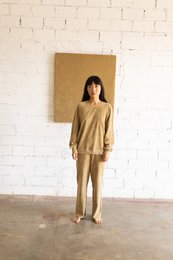 Beige terry cloth trousers with a relaxed, comfortable fit. Made of soft, absorbent terry material for a casual, loungewear style.