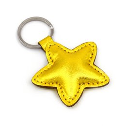 A golden star-shaped leather keychain with a metal ring.