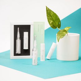 White cream product in a glass container with a white label and cap.