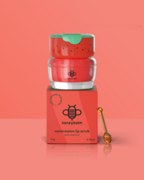  "Watermelon-shaped lip scrub with red color, green leaf top, playful fruit design, exfoliating beauty product."
