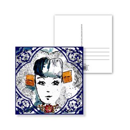 Postcard featuring a Delft blue tile design with a stylized portrait of a woman. The postcard has a decorative border and showcases the distinctive Delft blue and white color palette.