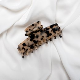 Chaming Hair Claw Clip - Amber, a stylish hair accessory made of a tortoiseshell-patterned material, suitable for holding back hair in a variety of hairstyles.