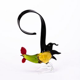 Glass animal figurine in the shape of a rooster with a red comb and yellow body.