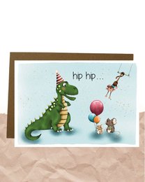 Colorful birthday card with a cartoon dinosaur and party decorations. The card has the text "hip hip..." printed on it.