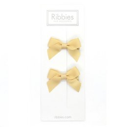Pair of beige bow hair accessories for kids