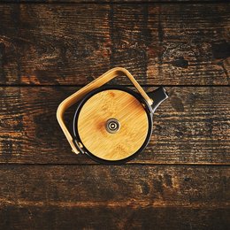 Black ceramic teapot with a round, tall shape.