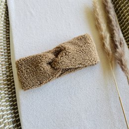 Beige teddy twist headband, made of soft, plush material, suitable for infants, toddlers, and adults.