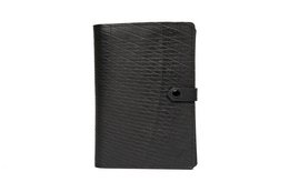 Black leather notebook with embossed duck design, featuring a snap closure and compact size for portability.
