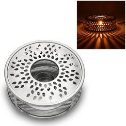 Stainless steel tea warmer with a perforated design for even heat distribution and a sleek, modern appearance. Suitable for use with various tea pots.