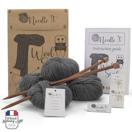 Gray knitting kit with needles and wool for making a scarf. Includes all the necessary materials for a beginner to learn knitting.