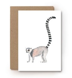A card with a hand-drawn illustration of a ring-tailed lemur, a primate species known for its distinctive black and white striped tail.