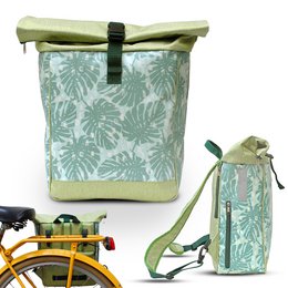 A green and white backpack with a tropical monstera leaf pattern. The backpack has a roll-top closure and adjustable straps, making it suitable for both casual and outdoor use.