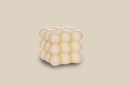 Creamy white bubble candle made from rapeseed wax, with a pillar candle shape.