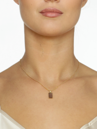 Elegant gold-toned necklace with a rectangular pendant featuring a dazzling design.