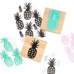 Pineapple-shaped rubber stamp for tropical-themed crafts and creations. Features a simple black and white pineapple design.