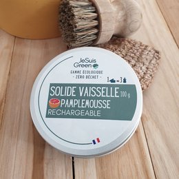 Solid, refillable dishwashing soap in grapefruit scent, packaged in a reusable container.