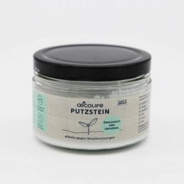 A white cleaning product in a glass jar with a black lid. The label on the jar says "Absolute Putzstein" and indicates it is an all-purpose cleaner.