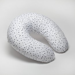 A white breastfeeding pillow with small black polka dots, designed for comfort and support during nursing.