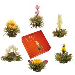 Blooming tea set with glass teapot, white tea leaves, and colorful flower buds. Includes a gift box.