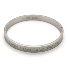 A silver-colored bracelet with the text "Carpe Diem Seize the Day" engraved on it. The bracelet appears to be made of metal and has a simple, minimalist design.