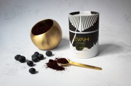 Açai and blueberry powder mix in a gold and black container, with superfood ingredients visible. Ideal for skin health and glow.