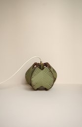 Khaki table lamp with electrical cords for ceiling or floor mounting.