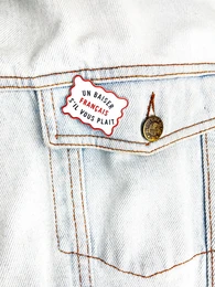 Embroidered patch with "Pin's France" text and decorative elements. Patch features a French flag-inspired design with red, white, and blue stitching.