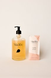  Glass hand soap set with rose scent, includes liquid hand soap and bar soap in floral packaging.