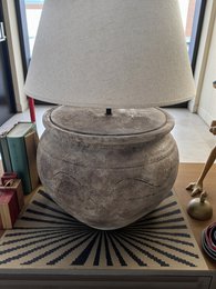  Handmade terracotta table lamp with a round, bulbous shape and a textured, earthy finish. Crafted in Portugal.