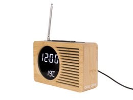 Retro-style bamboo alarm clock radio with digital display showing time and temperature.