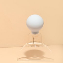  White glass cup with a round shape, suitable for massage oils or other body care products.