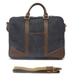 A stylish and durable weekend bag made of a combination of dark blue denim and brown leather. Features include a spacious main compartment, multiple pockets, and a detachable shoulder strap for versatile carrying options.