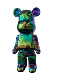 A colorful ceramic bear statue measuring 22cm in height. The bear features a vibrant green and blue iridescent finish with a unique abstract design.