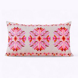 Decorative pillow covers in pink and orange with a floral pattern design. The covers are made of a soft, textured fabric and feature a vibrant, abstract floral motif in shades of pink and orange.
