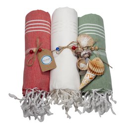 Colorful hammam towels in various shades of red, white, and green with decorative tassels and shells. Suitable for use as beach towels, bath towels, or home decor.