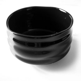 Black ceramic matcha bowl with a smooth, glossy finish. Suitable for preparing and serving traditional Japanese matcha tea.
