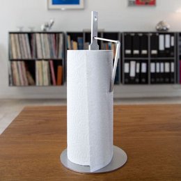 Rustic napkin holder with a simple, cylindrical shape made of a light-colored material, likely wood or ceramic.