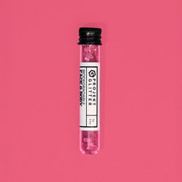  Vibrant red and pink glitter makeup product with a round shape.