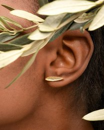 Dainty gold and sterling silver olive leaf stud earrings, handmade with a delicate, natural design.