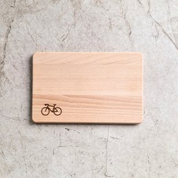  Wooden cutting board with bicycle icon, suitable for kitchen use.