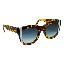 Oversized animal print sunglasses with a tortoiseshell frame and gradient blue lenses.